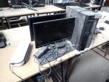 a desk with two computers and a mouse on it