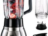 a blender that is sitting next to a glass of water