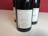 three bottles of wine sitting on a table