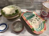 many plates and bowls sitting on a counter