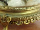 a gold plate with two elephants on it on a table