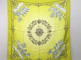 a yellow scarf with a picture of a bird and flowers on it