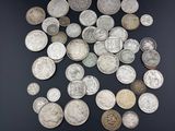 an image of a pile of silver coins on a black surface