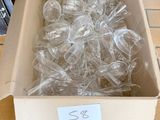 a box full of empty wine glasses sitting on a tiled floor