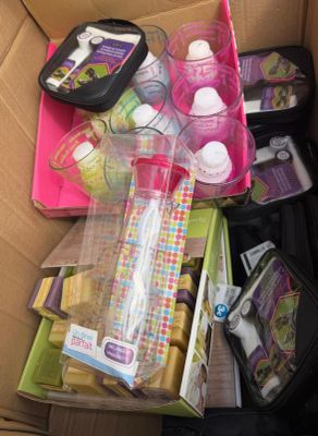 a cardboard box filled with baby products and other items