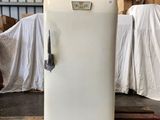 a white refrigerator sitting on a pallet in a warehouse
