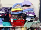a lot of clothes on a shelf in a store