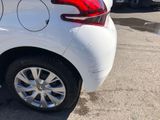 a white car parked in a parking lot with other cars in the background