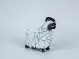 a black and white figurine of a sheep on a white background