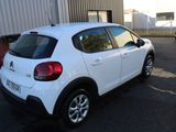 a white car that is parked in a parking lot