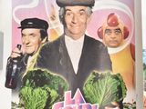 a poster of a chef holding a bunch of vegetables