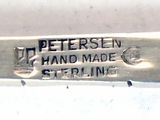 a close up of a silver spoon with a name on it