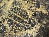 a close up of a gold plate with a crown on it
