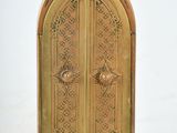 a small wooden door with ornate designs on it