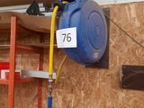 a blue hose attached to the side of a wall