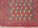an old rug with a red and yellow design on it