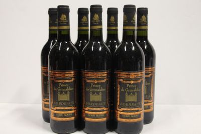 six bottles of wine are lined up on a white surface