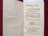 un vieux livre ouvert, dont la page, sur fond rouge, est visible