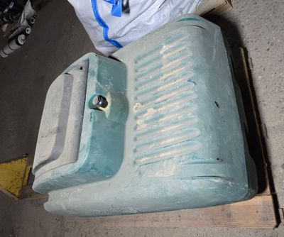 a blue water tank sitting on top of a pallet