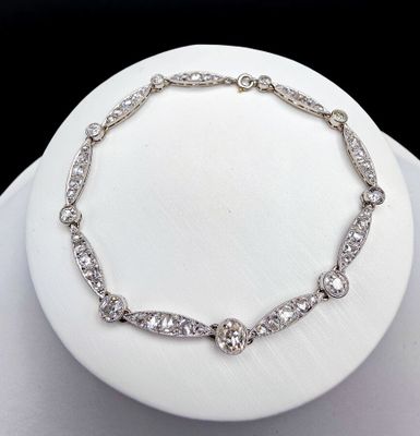 a white plate with a necklace and a bracelet on it