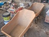 two wheelbarrows that are next to each other in a building