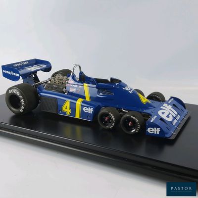 a model of a blue race car on a black stand