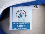 the label of a blue jacket with a white collar and blue trim