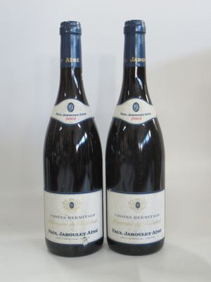 two bottles of wine sitting next to each other on a table
