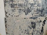 a metal sign on the side of a white building