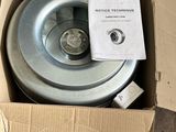 a box with a wheel inside of it on the floor