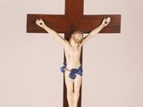 a wooden cross with a statue of jesus on it
