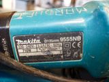 a close up of a blue machine with a black cord