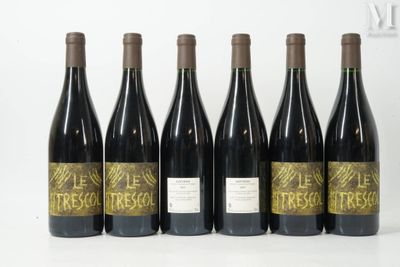 six bottles of wine are lined up on a white surface