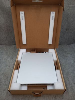 an open box with a laptop inside of it on a gray surface