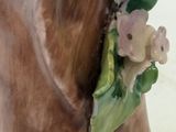 a figurine of a dog with flowers on it ' s head