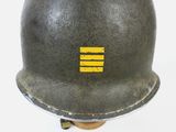 a close up of a helmet with a yellow stripe on it
