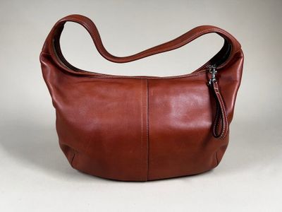 an image of a brown leather purse with a zipper on it