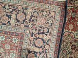 a close up of a rug with a cat laying on top of it