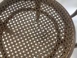 the back of a metal chair with holes in it