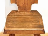 a wooden chair that is sitting on a hard wood floor