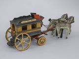 a toy horse pulling a carriage with a man on it