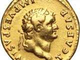 a close up of a gold coin with a head of a man