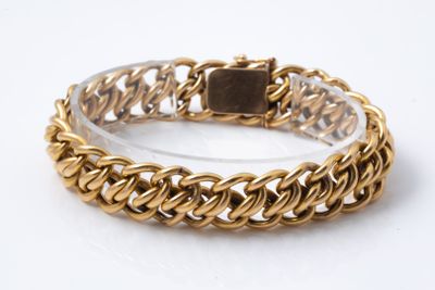 gold chain bracelet with a square stone in the center on a white background