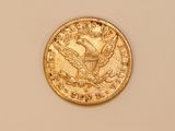 a close up of a gold coin with an eagle on it
