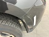 a close up of a car ' s front bumper with a denting on it
