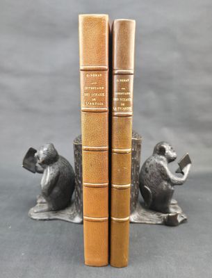 pair of bronze bookends of a monkey and a monkey sitting on a tree stump