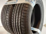 a close up of a tire on display on a white surface