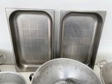many pots and pans sitting on the counter