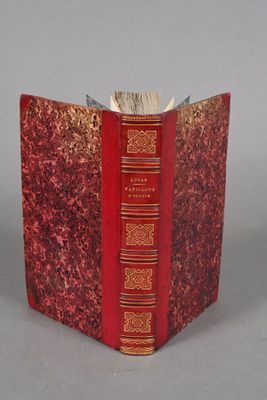 a red book that is open on a gray surface