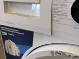 a washing machine that is sitting on the floor